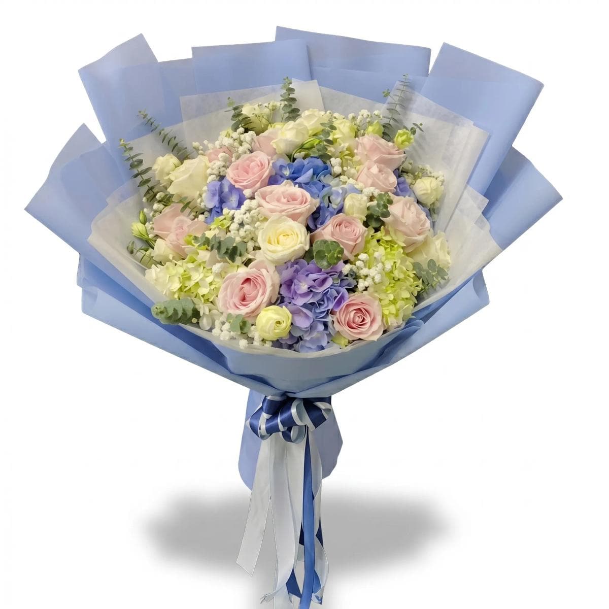 A soft mixed bouquet in white and pastel tones — thoughtfully arranged with seasonal blooms and light greenery for a clean, elegant look. Flower types may vary based on daily availability, while the overall style and color palette stay the same.